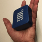 Waterproof Bluetooth speaker near a swimming pool, designed for outdoor use
