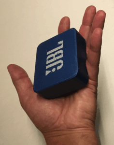 Waterproof Bluetooth speaker near a swimming pool, designed for outdoor use